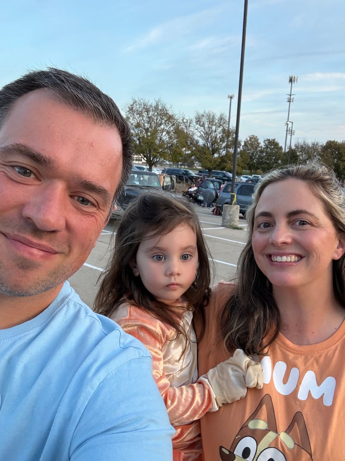 Kyle, Vera, and Amanda in their Bluey family costumes at trunk-or-treat